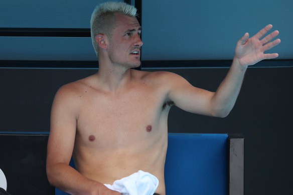 Tomic speaks to the umpire during his Australian Open match against Russian Roman Safiullin in 2022.