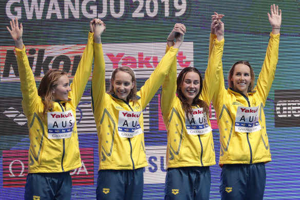 Australia's women's 4x200m freestyle relay team celebrate on the podium as they receive their gold medal at the World Swimming Championships.