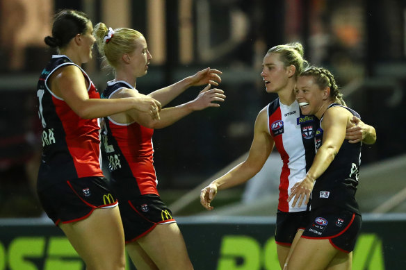 Jacqui Vogt celebrates with teammates after scoring for St Kilda against Geelong on Friday night.