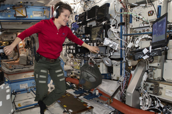 Astronaut Anne McClain looks at a laptop inside the US Destiny laboratory module of the International Space Station. 