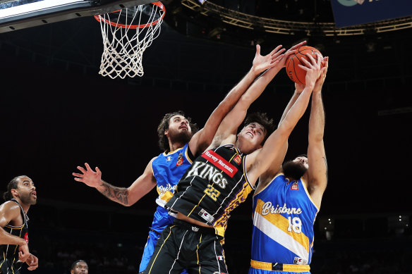 Sydney’s Alex Toohey battles for a rebound with Brisbane duo Tyrell Harrison and Tohi Smith-Milner. 