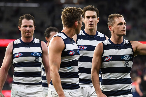 Leading Geelong players leave the field after the loss.