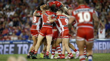 Dragons celebrate their golden point win over the Knights on Sunday night. 
