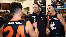 Nic Newman and Patrick Cripps congratulate Josh Fraser after a win.