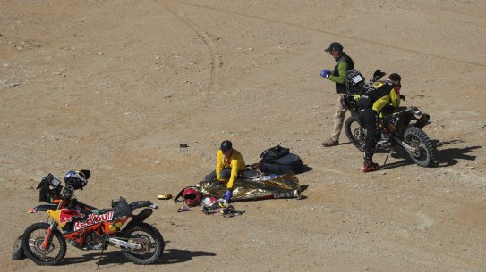 The body of Paulo Gonçalves of Portugal is covered with a blanket after a deadly fall during stage seven of the Dakar Rally between Riyadh and Wadi Al Dawasir, Saudi Arabia, Sunday, Jan. 12, 2020. Gonçalves, 40, died after an accident with his Hero motorbike. (AP Photo/Bernat Armangue)