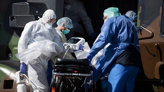 A patient infected with COVID-19 is loaded into a French military helicopter heading to the Saint-Gall hospital, Switzerland.