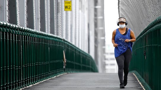 A jogger on the Story Bridge wearing a mask on Saturday, January 9.