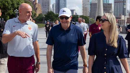 Prime Minister Anthony Albanese and his fiance Jodie Haydon walk along the Bund with former Socceroo and Shanghai Port FC Manager Kevin Muscat in Shanghai.