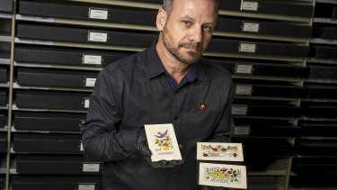 Australian War Memorial curator Garth O’Connell with the 1916 postcards linked to Indigenous WWI soldier Charlie Runga.