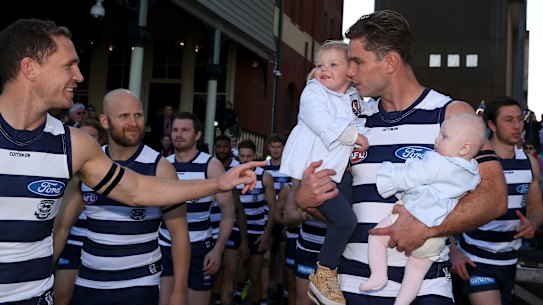 Tom Hawkins with his daughters before game 250 in 2019.