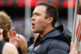 Brad Scott addresses his players during Essendon’s Anzac Day clash with Collingwood.