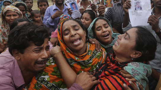 Bangladeshi relatives of garment worker Mohammed Abdullah cry as they as they arrive to collect his body at a makeshift morgue in a schoolyard near a building that collapsed in Savar, near Dhaka, Bangladesh in 2013.