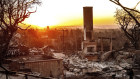 The sun rises behind a home destroyed by the Palisades Fire in the Pacific Palisades.