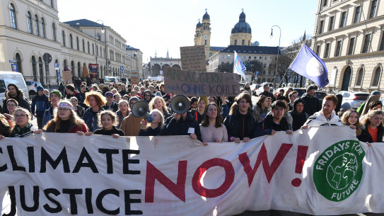 Fridays for Future protesters march through Munich's centre after a protest outside the headquarters of German engineering conglomerate Siemens which has a contract to provide systems to the Adani mine in Queensland.