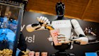 Tesla’s humanoid robot Optimus serves popcorn at a shopping mall in Berlin. “People see the humanoid form,” says Rodney Brooks, “and they think it’s going to be able to do everything a human can.”
