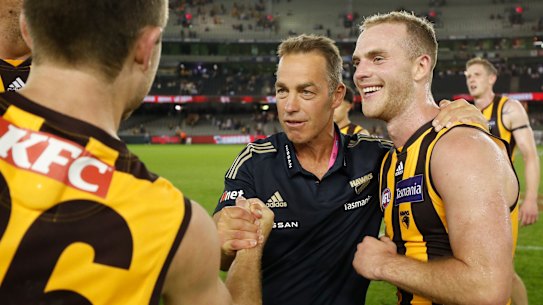 MELBOURNE, AUSTRALIA - MARCH 20: Alastair Clarkson, Senior Coach of the Hawks and Tom Mitchell of the Hawks celebrate during the 2021 AFL Round 01 match between the Essendon Bombers and the Hawthorn Hawks at Marvel Stadium on March 20, 2021 in Melbourne, Australia. (Photo by Michael Willson/AFL Photos via Getty Images)