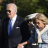 US President Joe Biden, left, and first lady Jill Biden hold hands as they arrive at Fort Lesley J. McNair, in Washington. 
