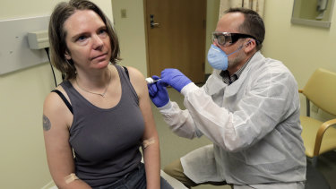 A pharmacist gives Jennifer Haller, left, the first shot in the first-stage safety study clinical trial of a potential vaccine for COVID-19, at the Kaiser Permanente Washington Health Research Institute in Seattle. 