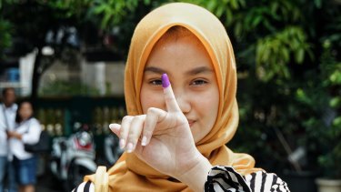 A first time voter from Bekasi, Indonesia, on Wednesday. Indonesians typically dip their finger in paint to signify they've casted their vote.