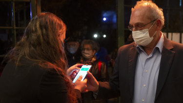 A man presents his “green passport”, proof he is vaccinated against the coronavirus, at the Khan Theatre in Jerusalem in February. 