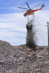 A helitanker extinguishes a fire at C & D Recycling in January 2018