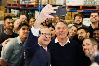 Opposition Leader Anthony Albanese and Deputy Labor leader Richard Marles take a selfie during a visit to meet with supermarket workers in the seat of Chisholm on Friday.