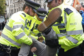 British police arrest a climate protestor in London. 