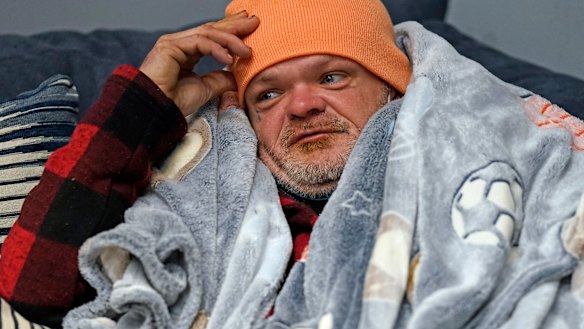 Brett Saint rests inside a Gallery Furniture store which opened as a shelter for those in need of food, water and heat in Houston. 