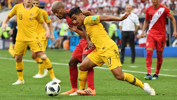 Sensation: Daniel Arzani is tackled by Andre Carrillo of Peru in Sochi.