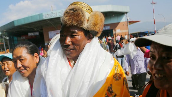 Nepalese veteran Sherpa guide Kami Rita, 49, is welcomed by his wife at the airport in Kathmandu, Nepal.