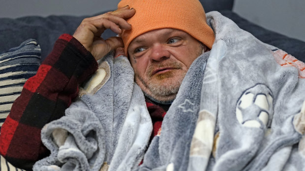 Brett Saint rests inside a Gallery Furniture store which opened as a shelter for those in need of food, water and heat in Houston. 