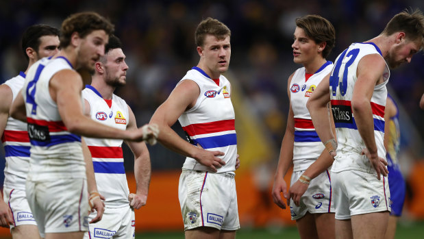 Jack Macrae (centre) and his dejected teammates after the big loss to the Eagles.