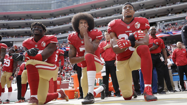 No longer allowed: Francisco 49ers Eli Harold, quarterback Colin Kaepernick and safety Eric Reid kneel during the national anthem in 2016.
