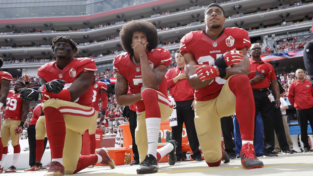 Game-changer: San Francisco 49ers' Eli Harold (from left), Colin Kaepernick and Eric Reid kneel during the national anthem before facing the Dallas Cowboys in October 2016.