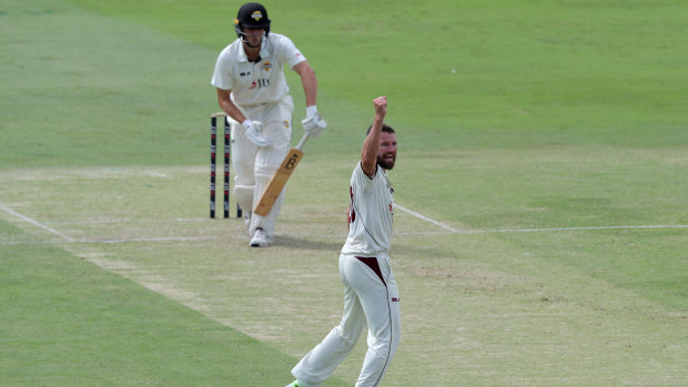 Michael Neser of Queensland celebrates after dismissing Western Australia's Aaron Hardie (left) during day 1 of the round 10 match at the WACA in Pert on Wednesday.