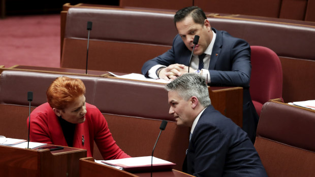 Mathias Cormann speaks with Pauline Hanson and Peter Georgiou in the Senate on Monday.