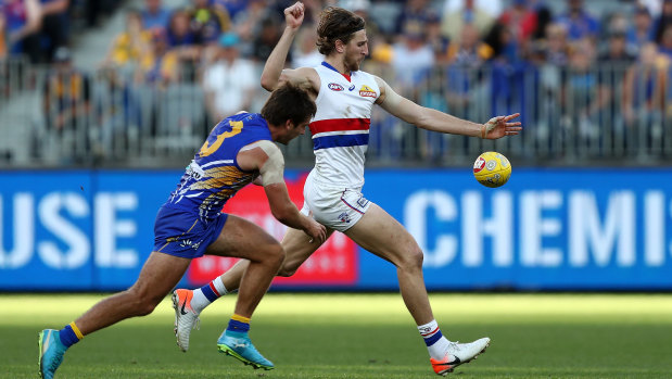 Dishing it up: Bulldog Marcus Bontempelli kicks under pressure from Andrew Gaff.