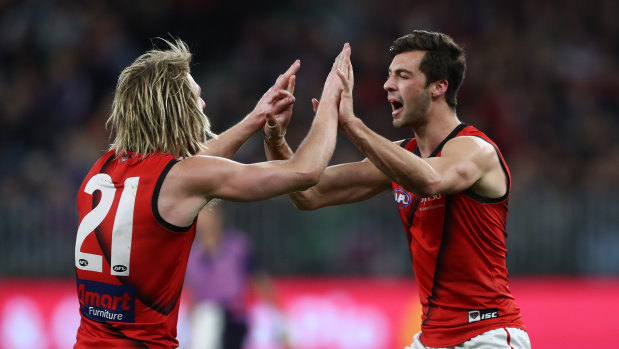 Kyle Langford and Dyson Heppell celebrate a goal in Essendon's finals-sealing win.