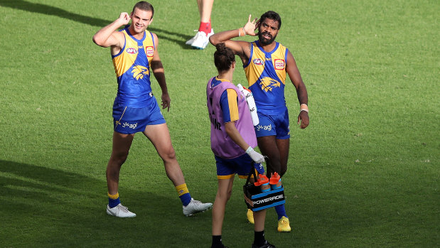 West Coast forward Liam Ryan, right, signals to the empty stands during round one.