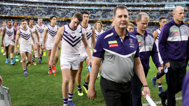Ugly incident: Fremantle coach Ross Lyon leads his team off the field after loss to West Coast that was blighted by Andrew Gaff's hit on young Docker Andrew Brayshaw.