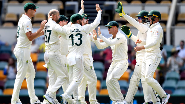 Nathan Lyon and Australia celebrate the wicket of Babar Azam on day four at the Gabba.