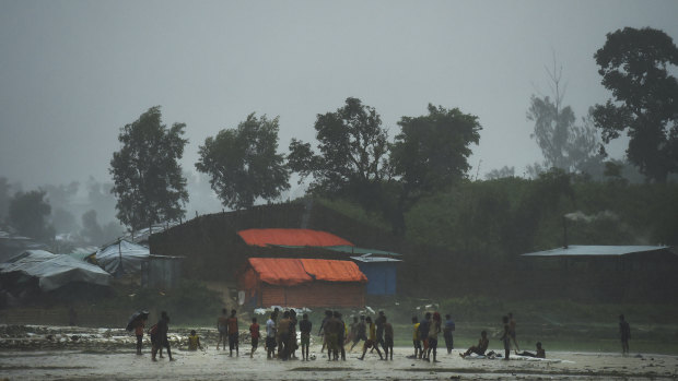Rohingya children play in a downpour at the world's largest refugee camp at Cox's Bazar last year.