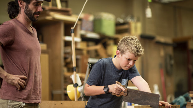 Woodwork enthusiast Lachlan Mayne, 13, under the supervision of expert Luke Mitchell  at the co-operative.