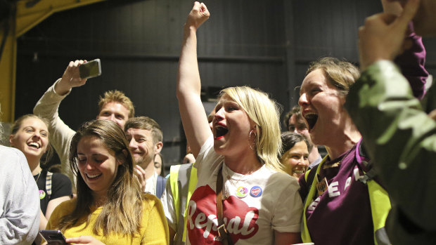 People from the "Yes" campaign react as the results of the votes begin to come in the Irish referendum on the 8th Amendment of the Irish Constitution.