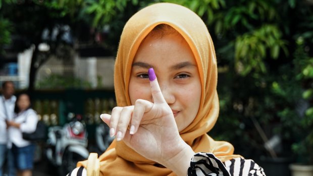 A first time voter from Bekasi, Indonesia, on Wednesday. Indonesians typically dip their finger in paint to signify they've casted their vote.