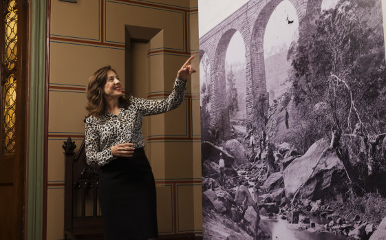 Dr Penny Stannard, senior curator at the NSW State Archives, with an image of Picton Viaduct from the Queen's Album from the late 1800s. 