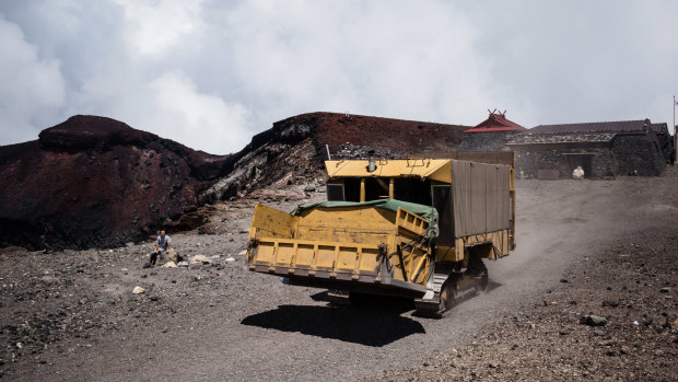 The crawler tractor heads back down after dropping off supplies at the summit of Mount Fuji.