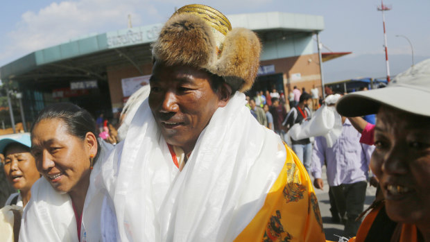 Nepalese veteran Sherpa guide Kami Rita, 49, is welcomed by his wife at the airport in Kathmandu, Nepal.