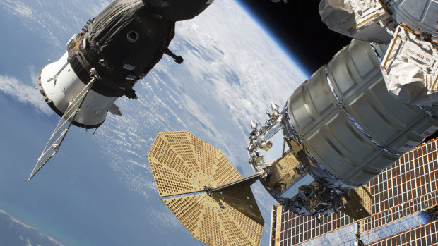 The Russian Soyuz crew craft, left, and the Northrop Grumman Cygnus space freighter are attached to the International Space Station. The small leak is on the capsule at left. 
