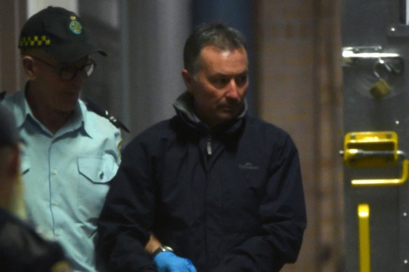 John Michael Fitzgerald is escorted to a prison van at Burwood Courthouse in Sydney.